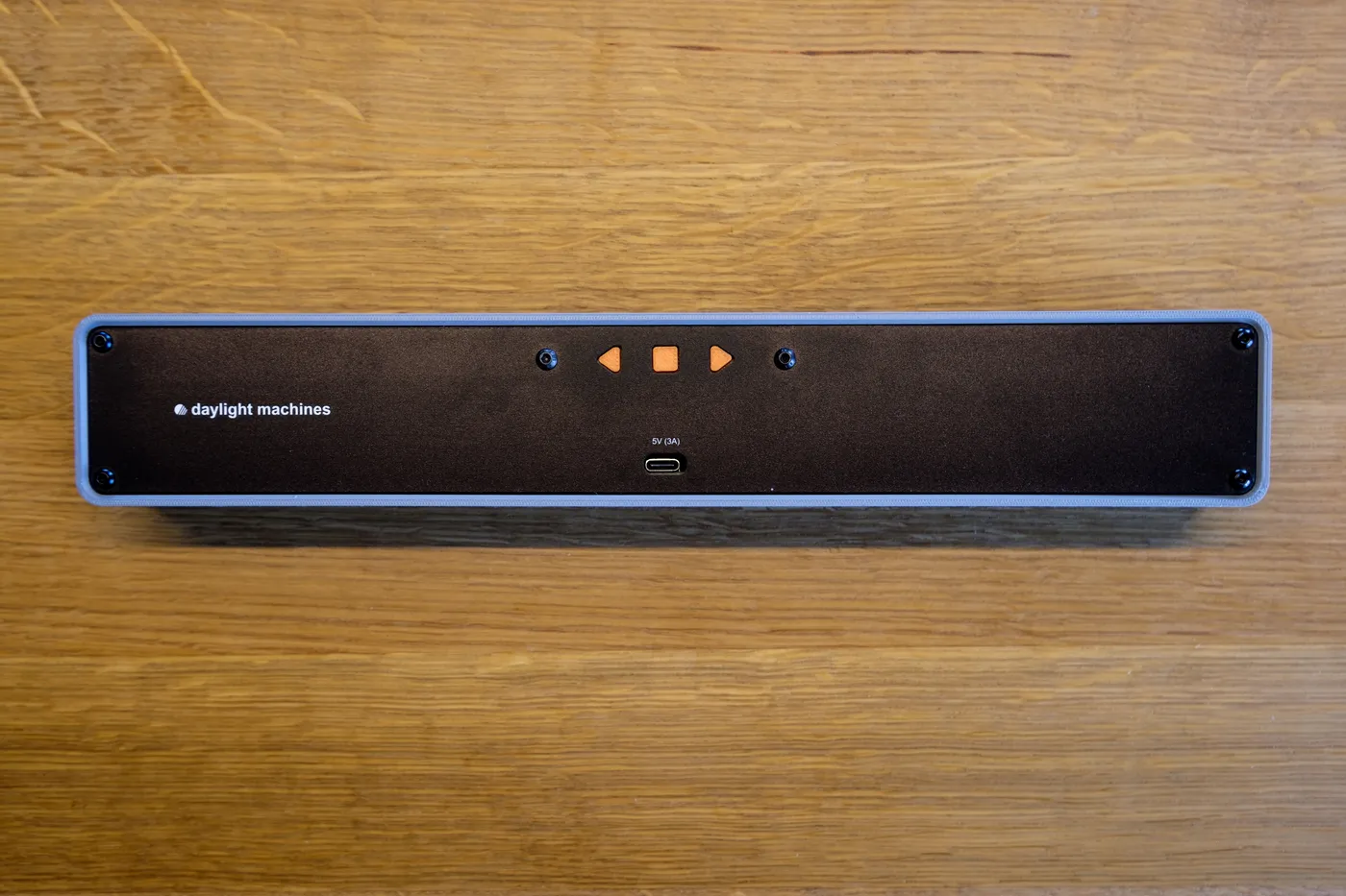 The back of the linear clock with the three buttons and the USB-C port